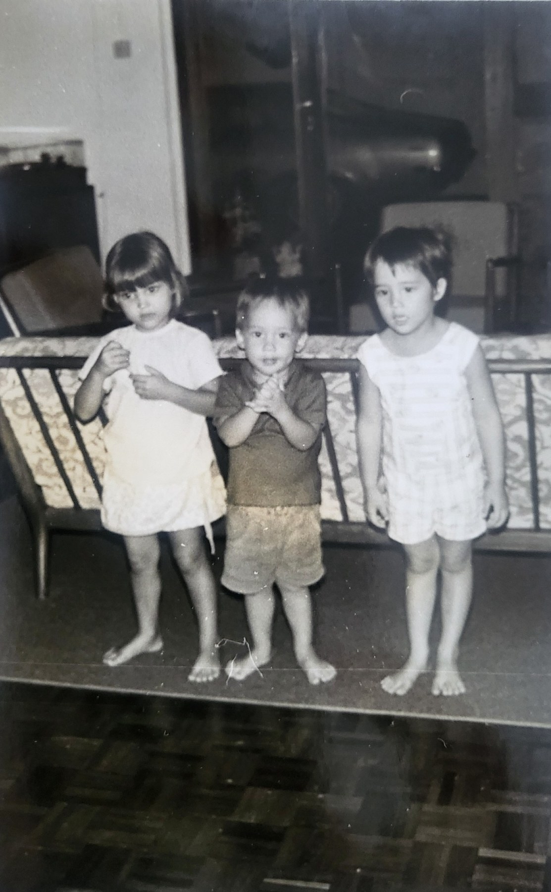 Three children together in an early family photograph