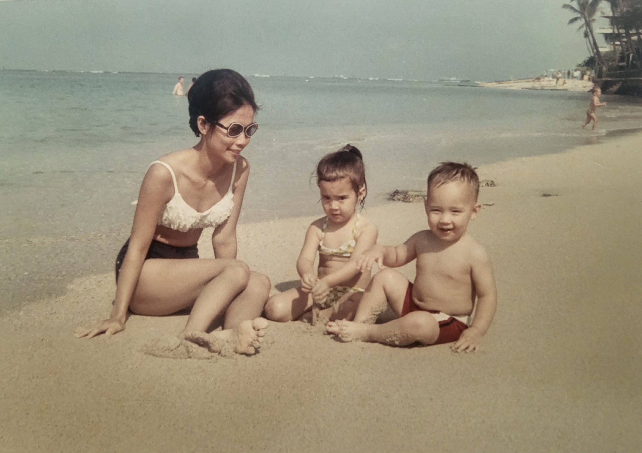 Lisa's mother with two children on the beach